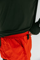 Red Apex running shorts with phone pocket on model by Nightclubs Suck