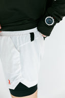 Athlete in white Apex performance running shorts by Nightclubs Suck