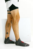 Gray low-cut Ghost performance socks side profile on model by Nightclubs Suck