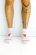 White low-cut Ghost running socks worn by an athlete by Nightclubs Suck