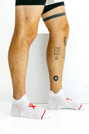 White low-cut Ghost performance socks side profile on model by Nightclubs Suck