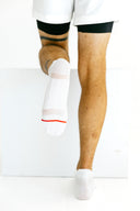 White low-cut Ghost running socks with red X detail by Nightclubs Suck