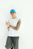 Athlete wearing the blue Queen City performance hat by Nightclubs Suck