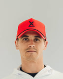 Runner wearing the red Redline performance hat by Nightclubs Suck