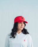 Athlete wearing the red Redline performance hat and NC hoodie by Nightclubs Suck