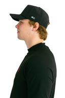 side profile of model wearing black performance hat with black X by Nightclubssuck