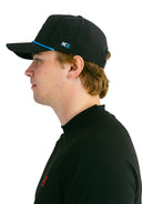 side profile of model wearing black performance hat with blue X by Nightclubssuck