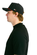 side profile of model wearing black performance hat with red X by Nightclubssuck
