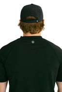 rear view of black performance hat with white X by Nightclubssuck