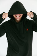 model wearing black performance hoodie with red X by Nightclubssuck