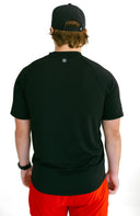 rear view of model wearing black performance tee with reflective logo by Nightclubssuck