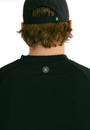 close up of reflective logo on model wearing black performance tee by Nightclubssuck